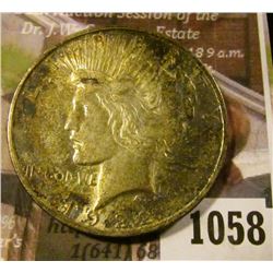 1058 . 1922-D Peace Silver Dollar, AU+, old album toning, value $35