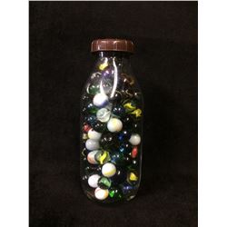 GLASS MILK BOTTLE FILLED WITH VINTAGE MARBLES