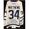 Image 1 : AUSTON MATTHEWS SIGNED REEBOK LEAFS JERSEY INSCRIBED "100TH CAREER NHL POINT" W/ FRAMEWORTH COA
