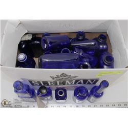 ASSORTMENT OF BLUE GLASS BOTTLES.