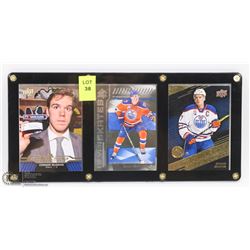 3 CONNOR MCDAVID HOCKEY CARDS IN CASE.