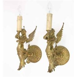 A pair of late 19th century gilt metal wall lights, in the form of female caryatids holding torch...