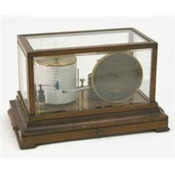 An early 20th century barograph, within glazed oak case on bevelled base with charts drawer 14ins...