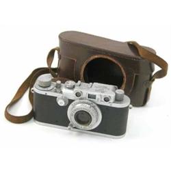 A Leica D.R.P. Ernest Leitz Wetzlar camera, no. 340390, with Leitz Elmar lens in brown leather ca...