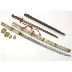 A Japanese carved bone Katana sword, two pairs of brass seppas and a RAF second world war bayonet...