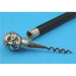 An ebonised walking stick, with associated plated novelty corkscrew handle, modelled as a male he...