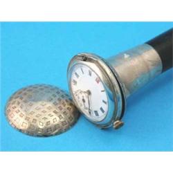 An ebonised walking cane, with associated Continental silver time piece handle, 35.5ins...