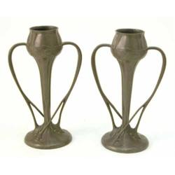 A pair of Liberty Tudric pewter tulip vases, with two elongated crossover handles, marked 029 on...