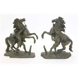 A pair of 19th century bronze figures of Marly Horses after Coustou, cast on naturalistic bases w...