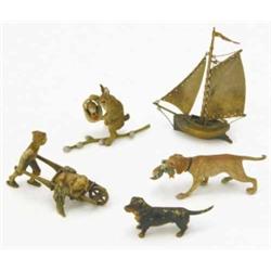 A Bergman cold painted bronze sailing boat, 3.75ins, a boy and pig in a barrow group and three ot...