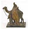 Image 1 : A cold painted spelter table lighter, modelled as a carpet seller upon a camel, 7ins...