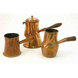 An early 19th century French copper chocolate pot, tapered base with turned wooden handle and two...