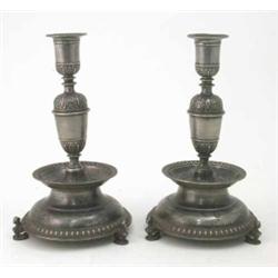 A pair of German 17th century style pewter candlesticks, of baluster form cast with scroll decora...