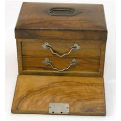 An olivewood jewellery box, with hinged lid and fall front enclosing a compartmented shelf and tw...