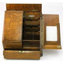 A Victorian golden oak stationery cabinet, with swing doors enclosing a compartmented interior, o...