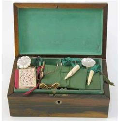 A Victorian inlaid rosewood work box, with compartmented interior housing various mother-of-pearl...