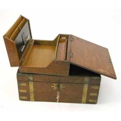 A 19th century brass bound mahogany writing slope and an oak stationary box, with a compartmented...