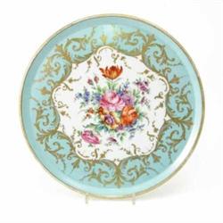 A 19th century French porcelain tray, circular, painted with flowers within a gilded bleu celeste...
