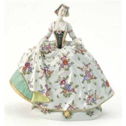 A Naples porcelain figure of a lady, wearing voluminous dress painted with flowers, 10in....