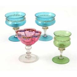 A pair of Venetian glasses, blue and aventurine with hollow baluster stems, a similar green glass...