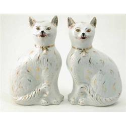 A pair of Victorian Staffordshire 'comforter' cats, each seated with gilded ornament, 13.5in....