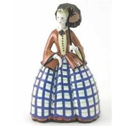 A Lenci earthenware figure of a lady, holding parasol and wearing blue-check crinoline dress, pai...