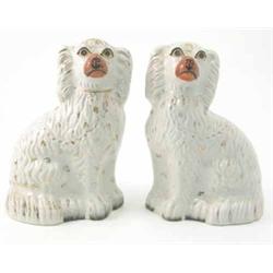 A pair of Staffordshire comforter spaniels, with gilded detail, 9in....