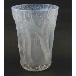 A large, opalescent glass vase, moulded with woodland in bold relief, 10in....