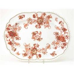 A Victorian bone china serving plate, oval with gadrooned rim, printed with chrysanthemums in rus...