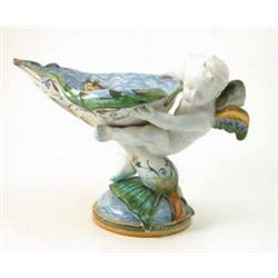 A Cantagalli majolica centrepiece, in the form of a cherub seated upon plant, supporting heart-sh...