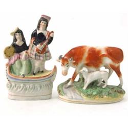 A Victorian Staffordshire cow and calf group, on oval base (5in.) and another, a highland couple,...