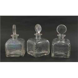 Three 19th century glass decanters, square shape with engraved foliage, complete with target stop...