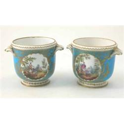 A pair of 19th century Sevres cache pots, painted with figures and woodland panels in gilt reserv...