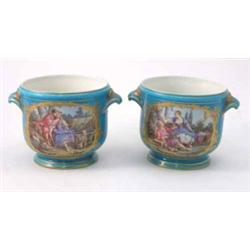 A pair of 19th century Sevres cache pots, finely painted with scenes of romantic dalliance within...