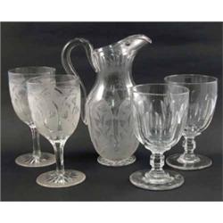 A Victorian glass jug, cut with foliage (9.5in.) and pair of goblets en suite (7in.) and two othe...