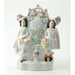 A Victorian Staffordshire flatback group, highland couple beside clock, 12.5in....