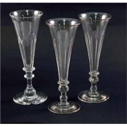 Eight near-matching champagne flutes, on knopped stems, 7in....