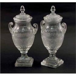 A pair of Victorian cut glass urns, with scroll handles, each with cover, acorn finial and steppe...