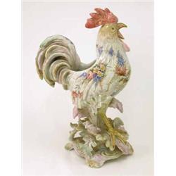 A 19th century French faience cockerel planter, painted with flowers, on leaf-moulded base, 17in....