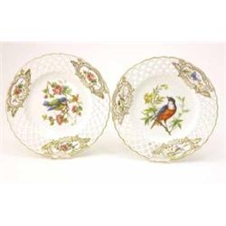 A pair of 19th century English porcelain cabinet plates, painted with birds within pierced border...