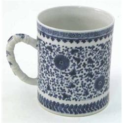 A large early 19th century Chinese tankard, painted with flowers and leaf-scrolls in underglaze b...