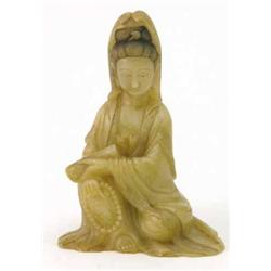 A Chinese carved soapstone figure of a seated Guan Yin, holding beads and a scroll, 5ins...