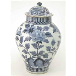 An 18th century Chinese transitional ginger jar and cover, baluster shape painted with peony blos...