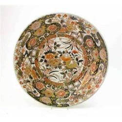 An early 18th century Arita charger, painted with peony and lotus plants in a deep underglaze blu...