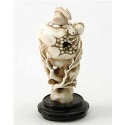 A Chinese ivory carving of a spider upon a pomegranate, 3.5ins...