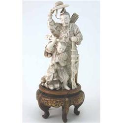 A Japanese carved ivory okimono, of a Samurai standing beside a boy fending off monkeys, signed,...