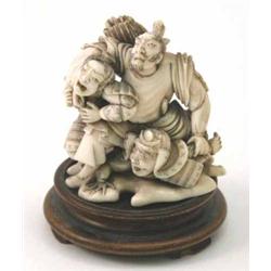 A Japanese ivory okimono, depicting three fighting warriors, 3ins...