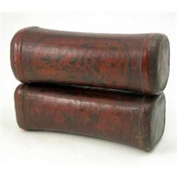 A pair of Eastern leather head rests, decorated with figures and flowers, 15ins...