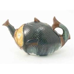 A majolica novelty teapot, in the form of a fish with scale-effect, 11in....