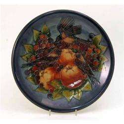 A Moorcroft 'Finches' charger designed by Sally Tuffin, decorated in shades of blue, green and oc...